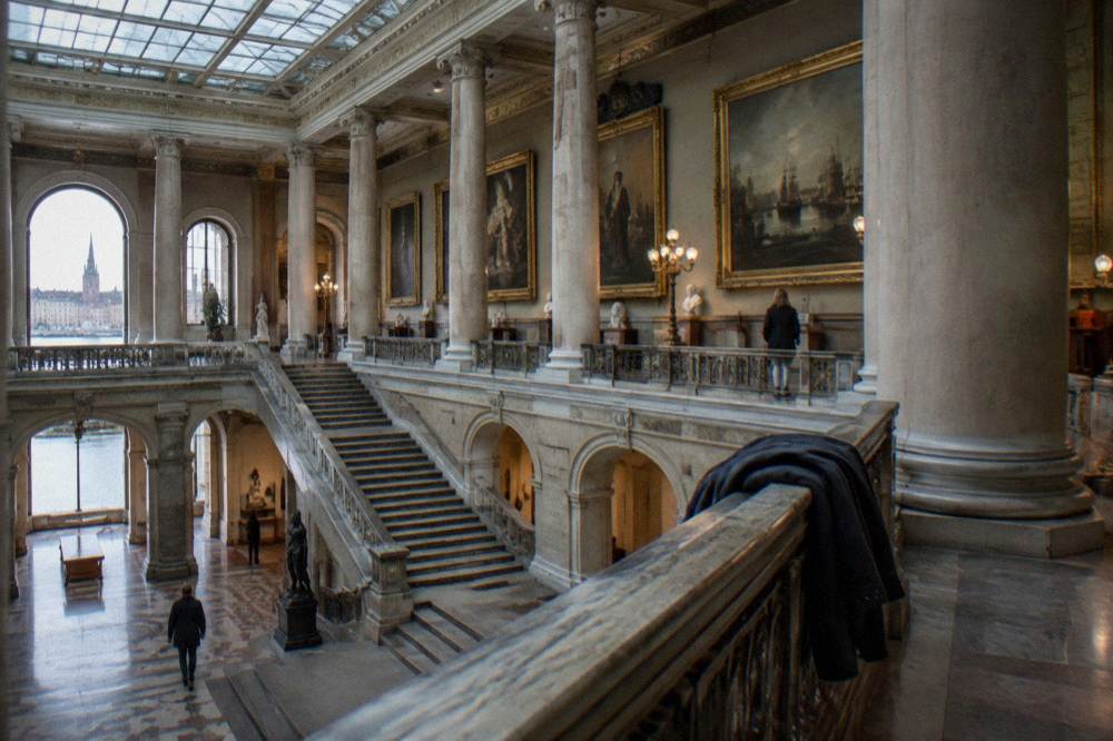 The grand staircase and sculpture gallery of a Stockholm museum interior