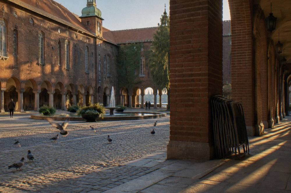 The enclosed courtyard of Stockholm City Hall with its central fountain and brick arcades