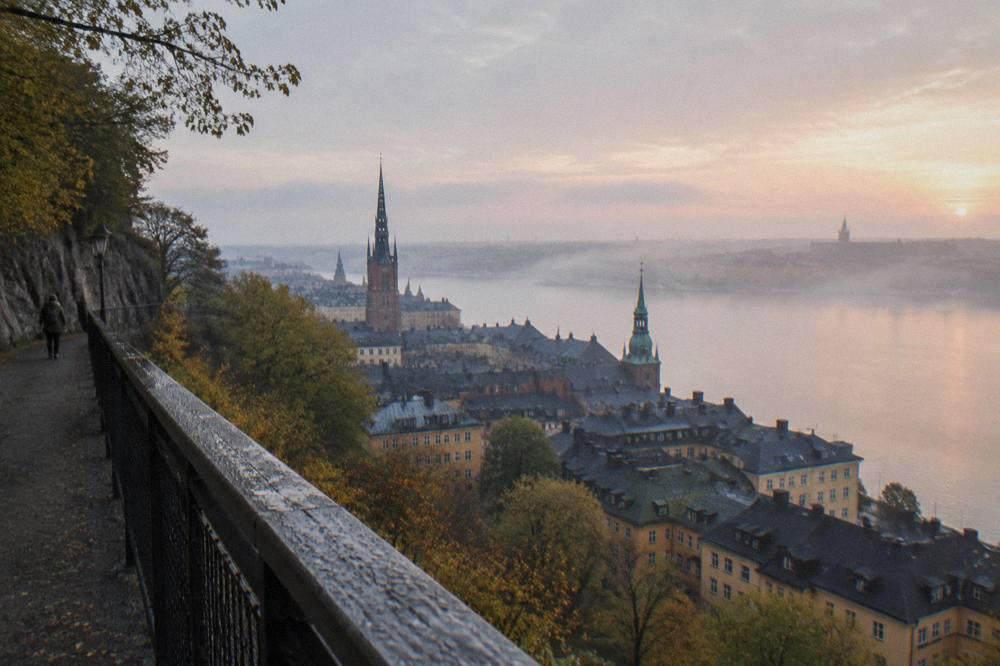View across the water from Monteliusvagen toward Gamla Stan's rooftops and church spires