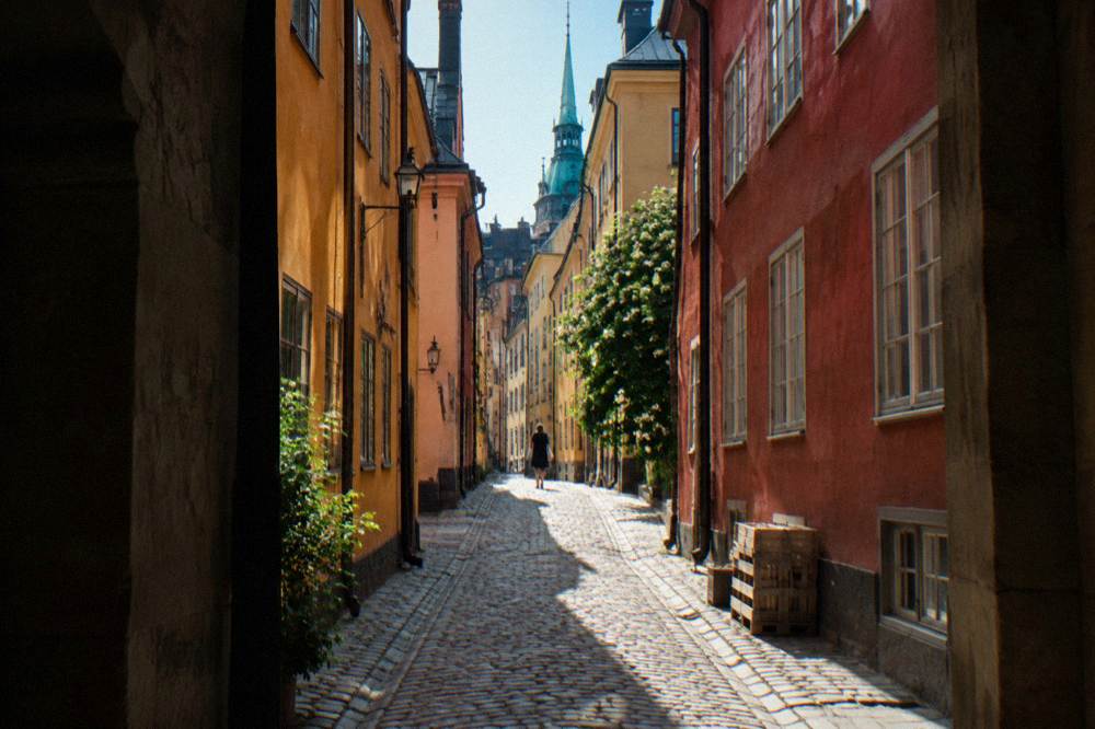 Colourful historic buildings along a narrow cobblestone street in Stockholm's old town