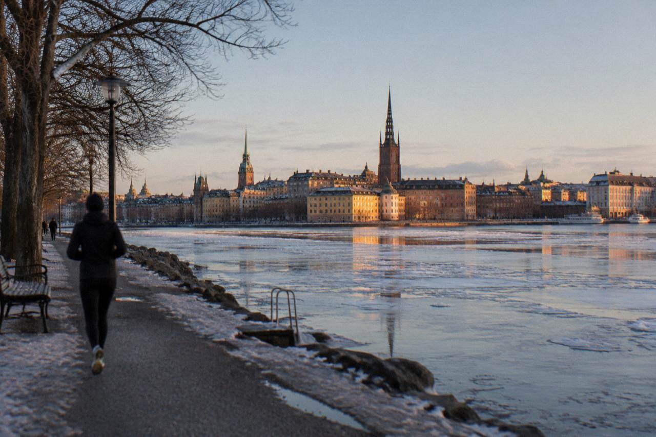 Stockholm's Gamla Stan old town rooftops and church spires seen across the water at golden hour