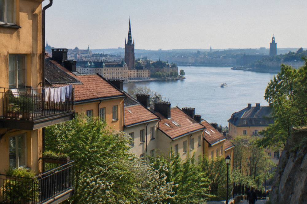 A view across Stockholm rooftops and water toward the Old Town from a high viewpoint