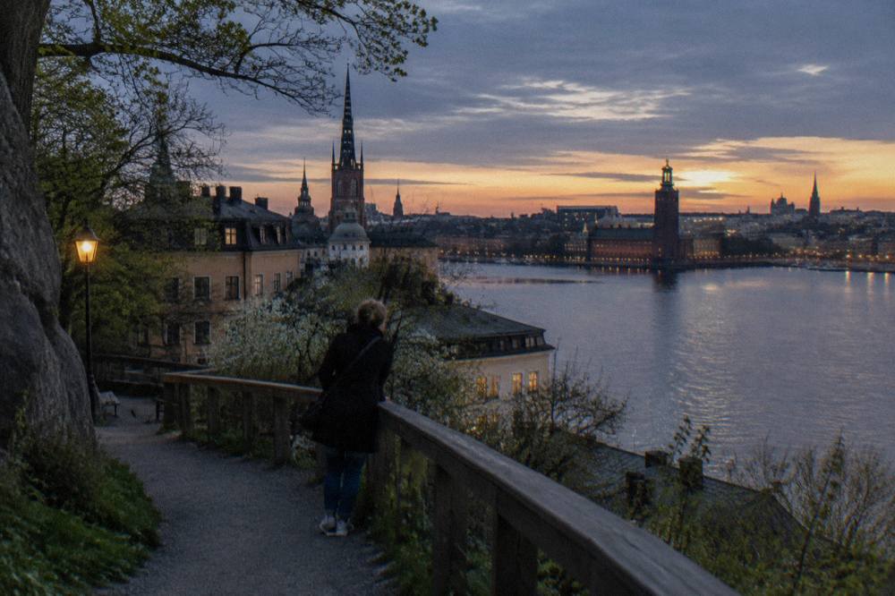 Evening view over Stockholm old town rooftops and water from the Monteliusvägen ridge path on Södermalm